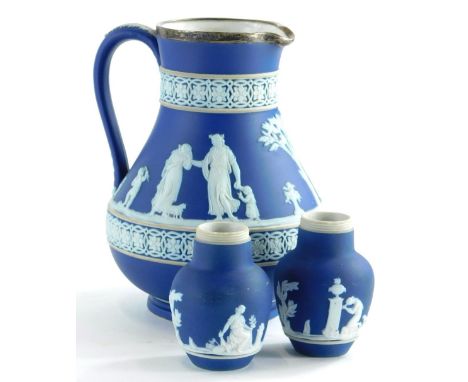 A Wedgwood dark blue Jasperware jug, with silver mount, (AF), and a pair of Adams dark blue Jasperware vases. (3)