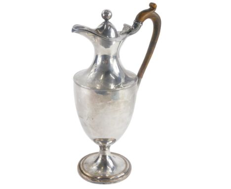 A 19thC silver plated urn shaped claret jug, with carved wooden handle on a domed foot, unmarked, 32cm high.