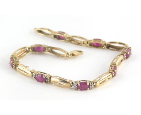 A ruby and diamond bracelet, with elongated yellow metal links, with oval cut rubies and four tiny diamonds to each section, 