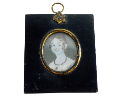 An early 19thC portrait miniature of a lady on ivory, in a black frame with gilt highlights, 7cm x 5«cm.