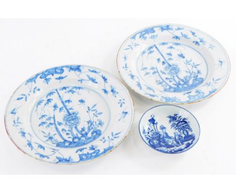 A pair of late 18th/early 19thC Delft plates, each decorated in Chinese style with blue flowers and leaves, within an iron re