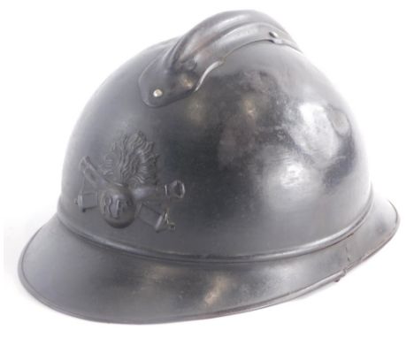 A French First World War metal helmet, with applied badge stamped RF and leather interior.
