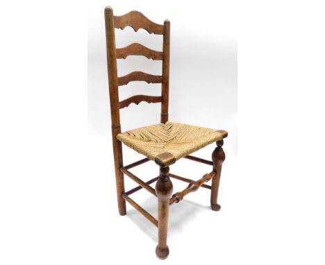 A Lincolnshire type ash ladder back chair, with a rush seat on cabriole legs.