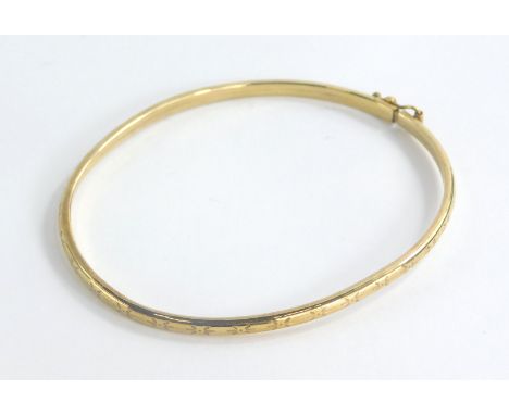 A silver hinged bangle, with star etched design, and safety clasp, yellow metal unmarked, 6cm diameter, 3.2g all in, boxed.