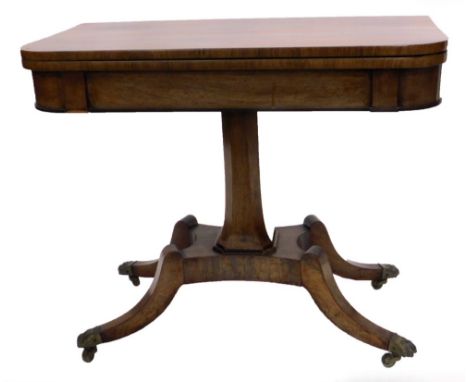 A George IV rosewood card table, the rectangular top with rounded top enclosing a baize lined interior, on a chamfered taperi