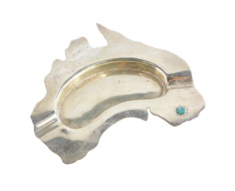 A novelty white metal ashtray, inset with an opal, possibly moulded in the shape of Australia, stamped to underside Prouds, 1