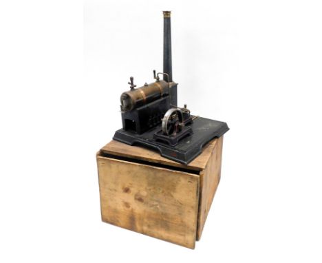 An early 20thC tin plate static engine, modelled with a brass and copper cylinder, ebonised and brass fittings, on a rectangu