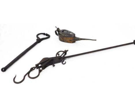A collection of bygones, to include iron scales, a set of Blacksmiths tools, and an oil can.
