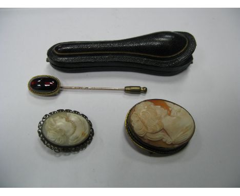 A XIX Century Stick Pin, the elongated oval cabochon collet set, in a case; together with two oval shell carved cameo brooche