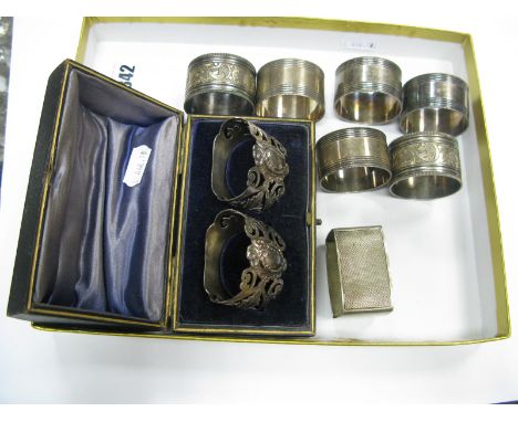 A Decorative Pair of Openwork Napkin Rings, in original fitted case; together with a hallmarked silver engine turned napkin r