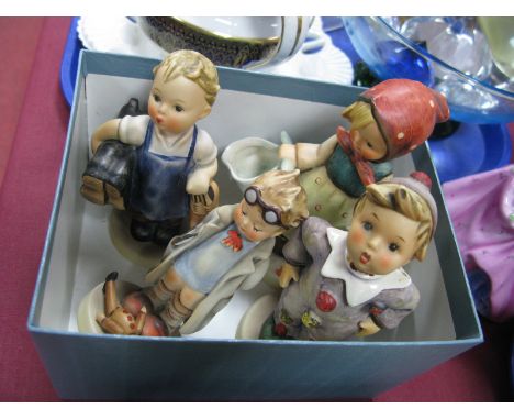 Hummel Pottery Figures, 'Mothers Boy', 'Carnival' (repaired), 'Boy Holding Shoes and Boots', all on circular bases. (4)