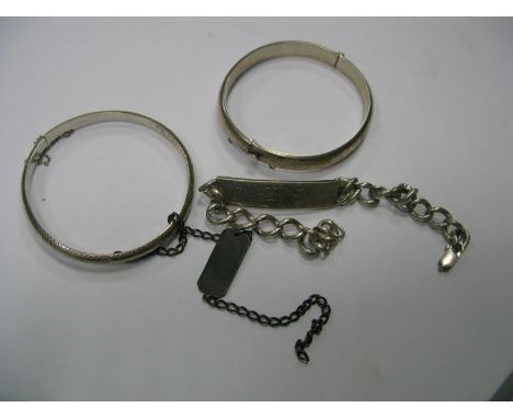 A Hallmarked Silver Bangle; together with another bangle and two identity bracelets.