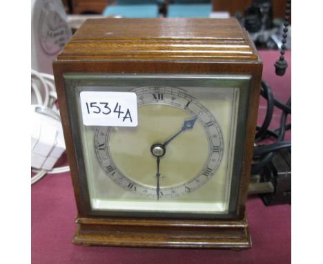 Elliott Walnut Cased Mantel Clock, on brass bun feet.