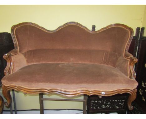 A 19th century rosewood sofa with upholstered seat and back within a show wood frame with shaped carved and moulded outline r