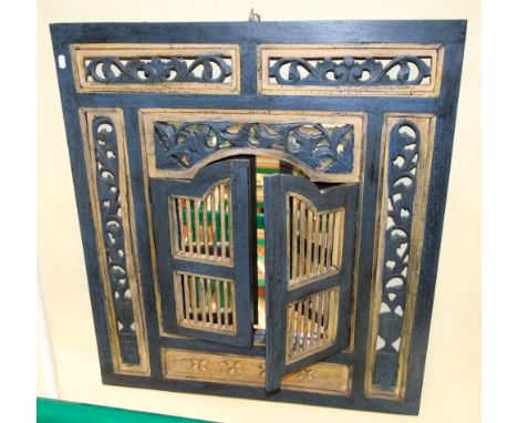 A Chinese carved and pierced panel of rectangular form enclosing a pair of arched doors with stick work divisions enclosing a