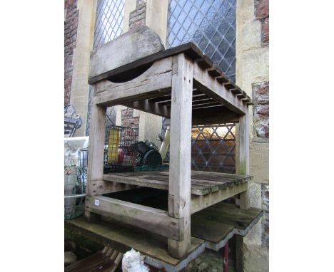 A weathered vintage pine two tier potting/work bench with raised three quarter gallery and open slatted tiers 