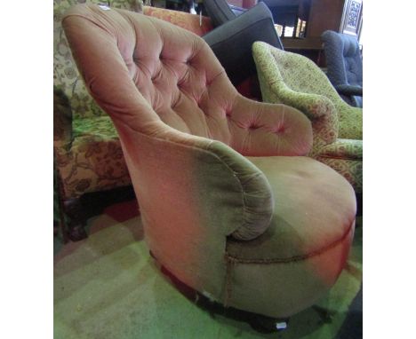 A Victorian drawing room chair with shaped outline, pink dralon upholstered with button back raised on turned bun forelegs wi