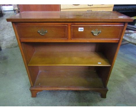 A reproduction yew wood veneered dwarf bookcase with two frieze drawers over an open adjustable shelf raised on bracket suppo