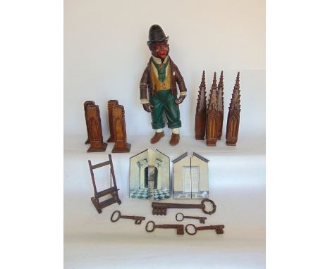 A resin figure of a standing monkey dressed as a Victorian pauper, together with further architectural oak wooden carvings, a