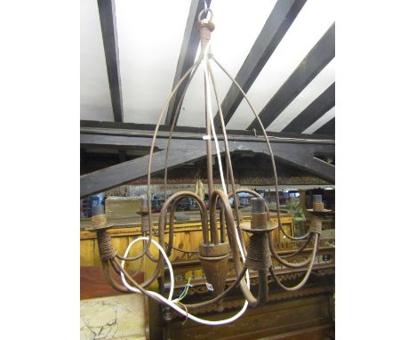An ironwork hanging ceiling light with five simple scrolling branches 