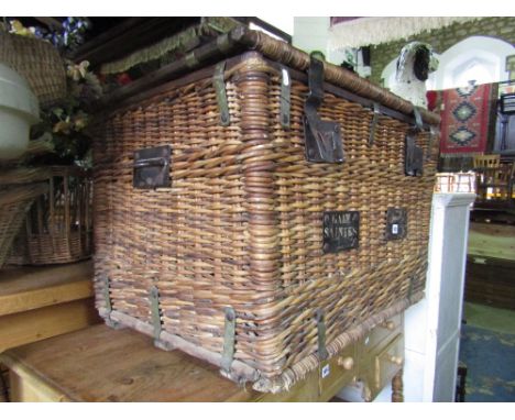 A good vintage wicker laundry/travelling basket with rising lid and sturdy steel work fittings, 80 cm