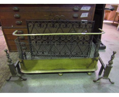 A 19th century brass and wirework fender raised on bun supports, a pair of cast brass and iron fire dogs with knop finials an