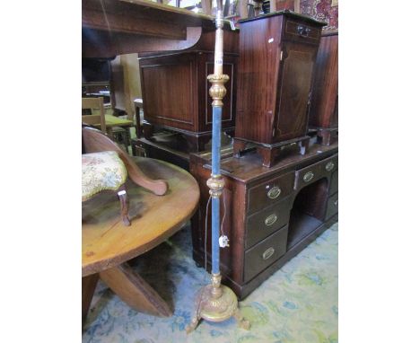A decorative gilt standard lamp with partially upholstered blue velvet column raised on a disc shaped base with petal collar 