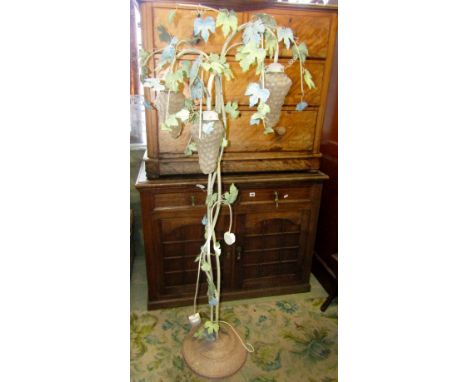 A contemporary painted metal standard lamp, the stem in the form of entwined fruiting vine with moulded glass shades in the f