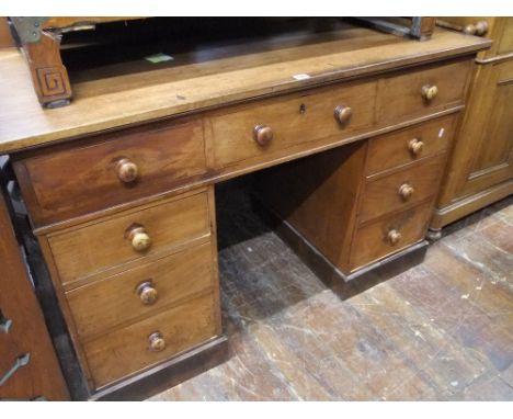 A 19th century mahogany pedestal desk of nine drawers set on a plinth base, 122cm wide