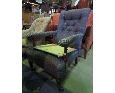 A Victorian open armchair with blue ground lattice patterned upholstery, button back and arms, raised on turned supports and 