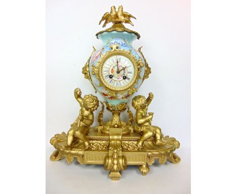 A 19th century French gilt spelter and porcelain mantle clock in the rococo manner, the 3.5" painted enamel two train dial up