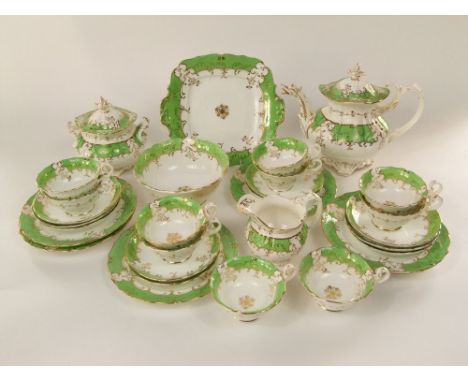 A collection of mid-19th century tea wares with green and gilt border decoration comprising tea pot, covered sucrier, slop bo