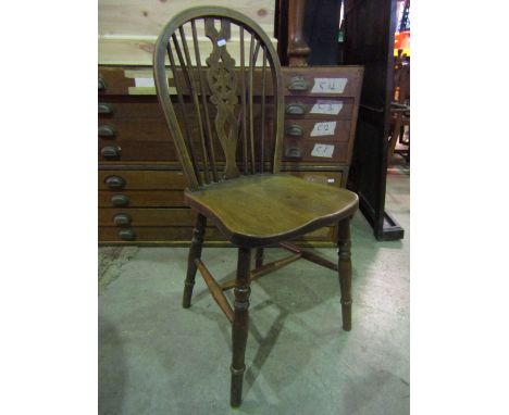 A set of five Windsor stained elm and beechwood hoop and stick back dining chairs with central wheel splats