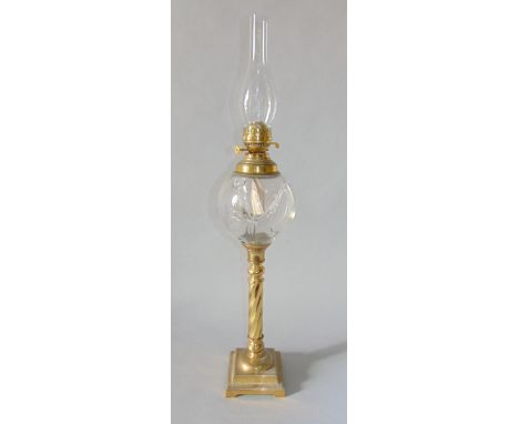 An interesting 19th century brass oil lamp, with globe glass reservoir upon a barley twist column in stepped square base, 70c