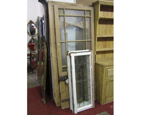 Two reclaimed stripped pine framed partially glazed panelled doors with frosted panels complete with locks and fittings, toge