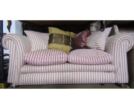 A vintage two seat Chesterfield sofa with rolled arms, cream ground and alternating red striped upholstery and feather filled