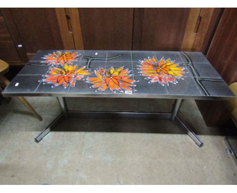 An Italian style tile topped table decorated with orange flowers upon a shaped chrome base, 110 cm long approx.