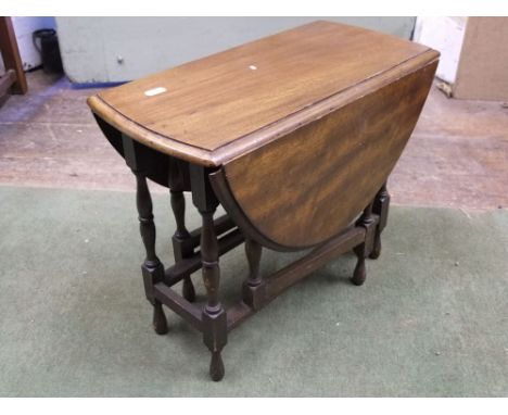 A miniature gate leg table on eight turned supports, 45cm max