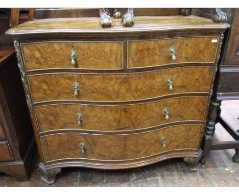A good quality Edwardian figured walnut serpentine chest of three long and two short graduated drawers with applied gilded de