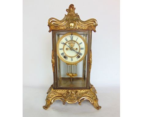 A 19th century rococo style cast ormolu four glass mantle clock with two train 4" dial with open escapement and mercury pendu