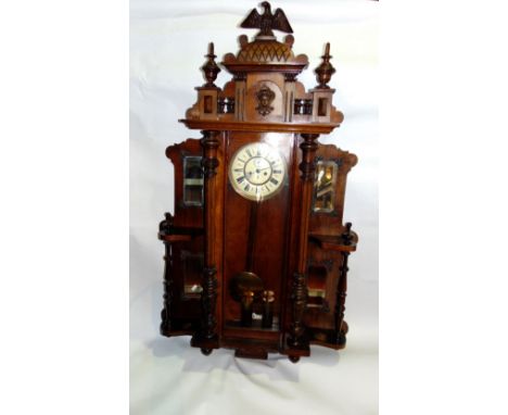 An impressive walnut Vienna two train regulator wall clock, the 8" dial with Roman numerals, the architectural case flanked b