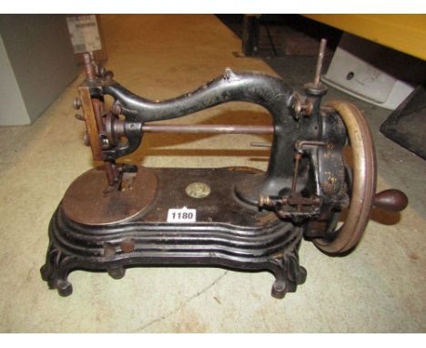 A vintage Bradbury cast iron hand operated sewing machine with worn gilt transfer detail