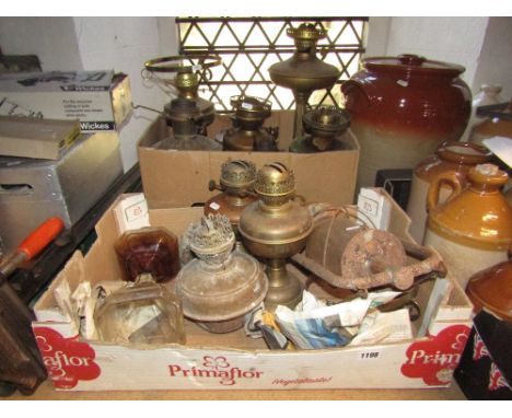 A collection of vintage brass and copper oil lamps of varying design, storm lantern, etc