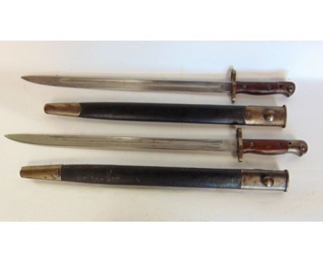 Two 1907 pattern English bayonets - the blades marked Wilkinson, each within leather sheaths