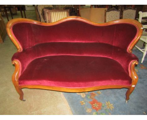 A 19th century two to three seat sofa with plum ground upholstered seat, back and arms within a walnut show wood frame with s