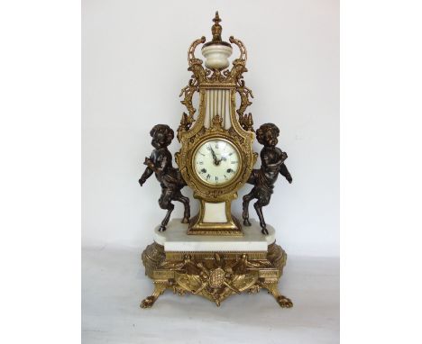 A 19th century style cast metal and marble lyre figural mantle clock, the two train 3.5" dial flanked by bronzed cherubs with