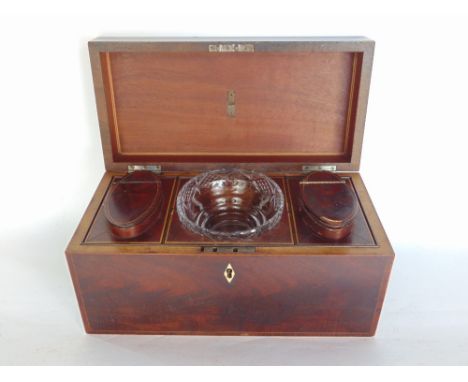 A 19th century flame mahogany tea caddy, the hinged lid enclosing a fitted interior to include two hinged lid canisters and a