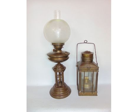 A brass oil lamp, the base decorated with a cherub between three Corinthian columns upon a stepped circular base, 68cm high i