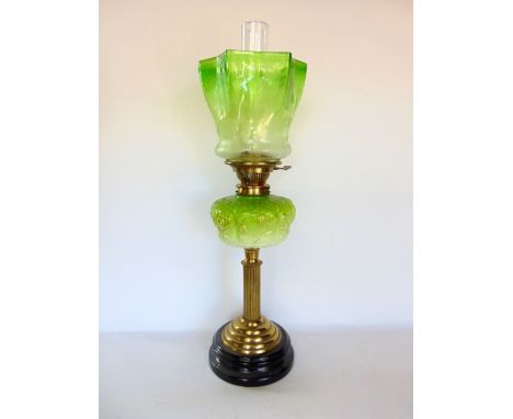 A 19th century brass and glass oil lamp, with lobed green glass shade decorated with flowers upon an opaline green and white 