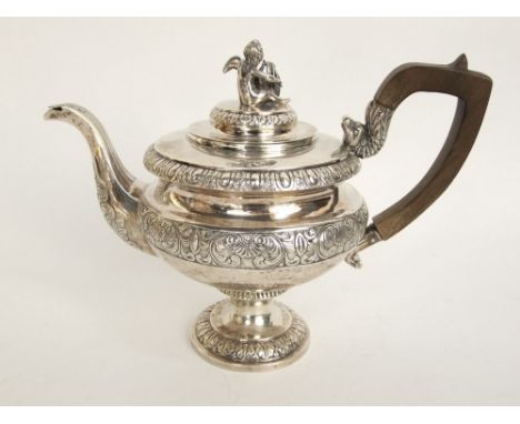 A continental silver pedestal tea pot, the lid mounted by a seated cherub playing a lyre harp, with scrolled serpent handle a